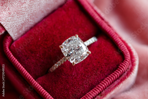 Cushion cut diamond engagement ring resting in a ring box