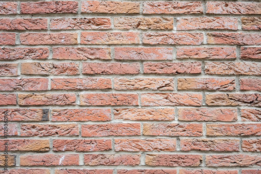 Fototapeta premium Stone wall with much brown bricks of the modern building.
