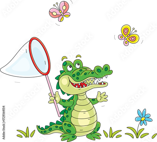 Happy green crocodile catching butterflies with a toy butterfly net on a summer lawn with flowers, vector cartoon illustration on a white background