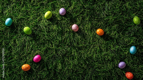 A bright green lawn with hidden colorful Easter eggs scattered on the grass