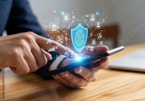 Wallpaper Mural A close-up of a man's hand interacting with a smartphone, featuring digital security icons illuminated above. Torontodigital.ca