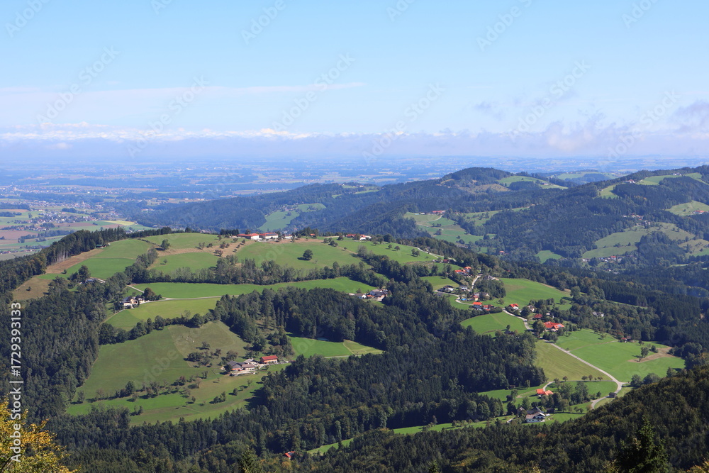 Naklejka premium Idyllic panorama of a hilly agricultural landscape, farmland scenery, rural countryside, scenic view