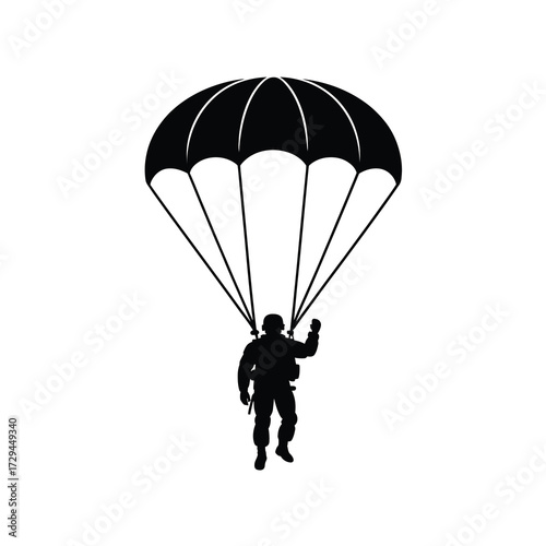 Silhouette of a skydiver descending with a parachute open mid-air