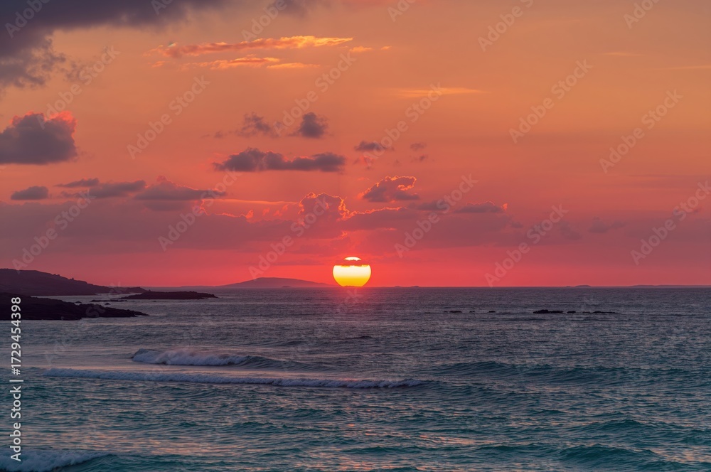 Fototapeta premium Stunning vibrant dawn over the ocean with striking clouds and glowing sunlight