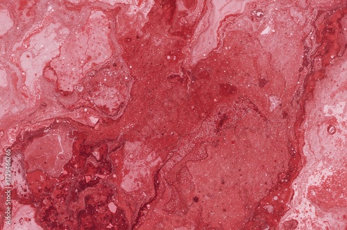 Close-up of elegant red and pink marble surface with sparkling seamless design in overhead perspective. Text space included.