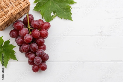 Fresh grapes on a white woo...