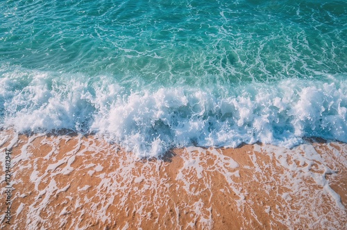 Sandy beach with frothy sea...