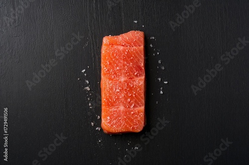 Raw salmon fillet sprinkled...