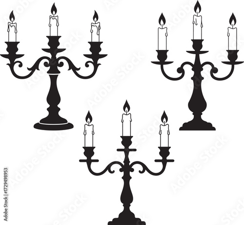 Three ornate candelabra with lit candles in silhouette isolated on white background