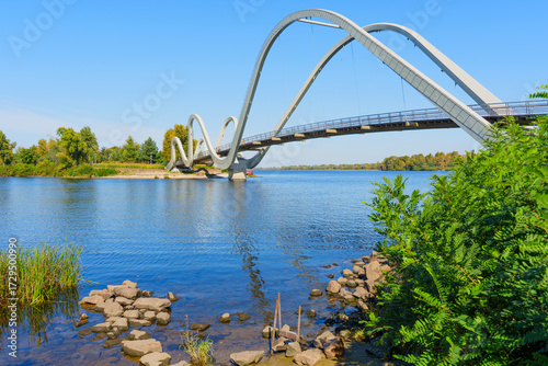 Tableau sur toile Wavy Pedestrian Bridge Waves Over The Serene Dnipro River In Kyiv's Scenic Lands