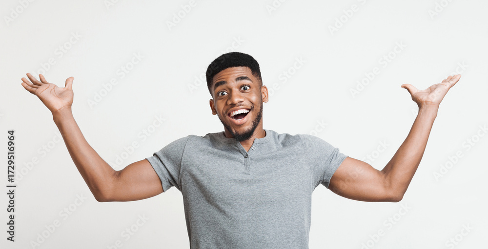 Fototapeta premium Excited african-american man winner raising his hands with great happiness, winning game, having success, being glad to achieve his goals. Victory and triumph concept
