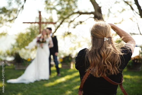 A woman photographing a couple on their wedding day. Wedding photography in Ontario, Canada.