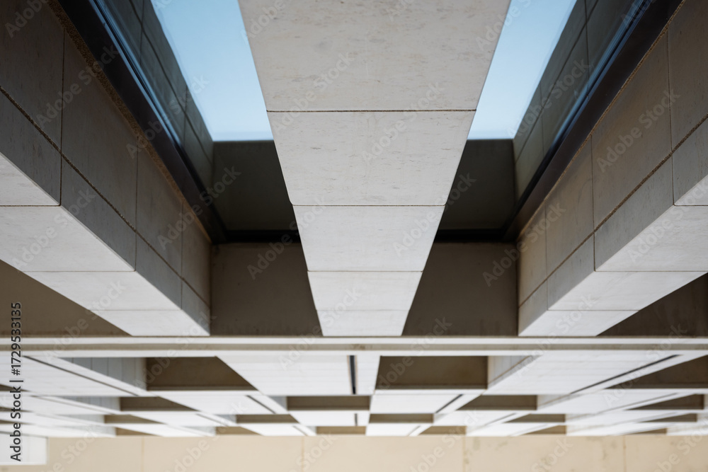 Obraz premium Modern architectural detail with geometric patterns and shadows, showcasing sleek urban design elements in a minimalistic style.