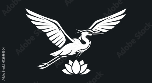 Graceful white heron with spread wings flying over a lotus flower.