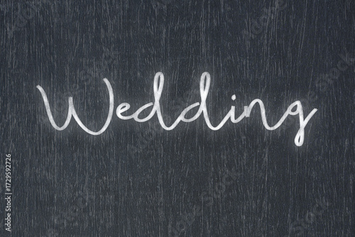 A blackboard with a handwritten chalk message that says wedding, a powerful symbol of business success and motivation in educational and production concepts.