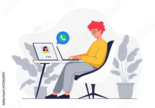 Young man with red hair video calling on laptop at desk