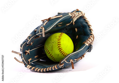 A scuffed yellow softball in a blue leather mitt, isolated on white. Essential gear for a game of fastpitch or slowpitch, representing teamwork and athletic competition