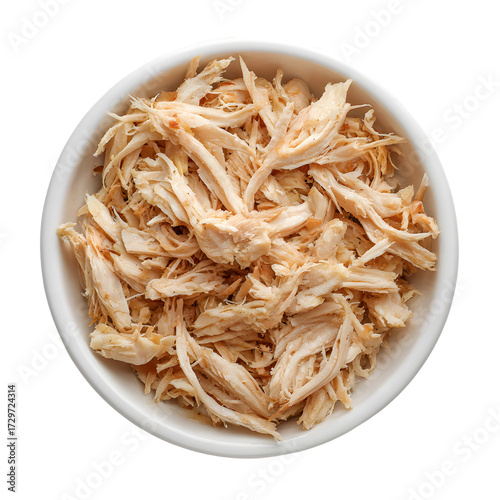 Bowl of savory shredded chicken. Cooked and pulled chicken meat for tacos, salads, or sandwiches. Meal prep ingredient isolated on black background.