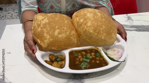 Big size chole bhature served with onion and sabji