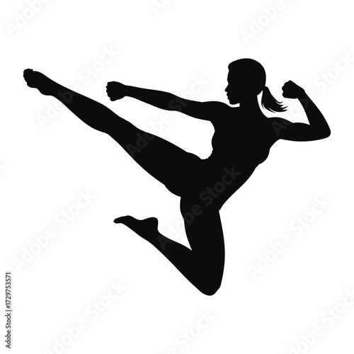 A woman's powerful silhouette displaying her acrobatic kicking ability