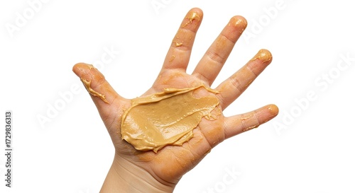 A human hand covered in smooth peanut butter spread thickly across the palm and fingers