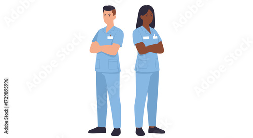 Two healthcare workers in blue scrubs stand with arms crossed