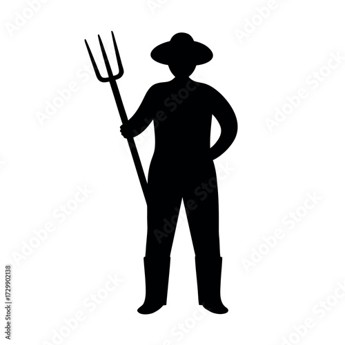 Silhouette of a farmer wearing a hat and holding a pitchfork standing confidently
