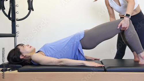 A woman taking a machine Pilates lesson