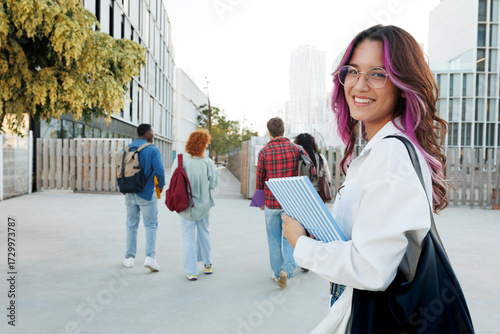 Smiling student walking on university campus