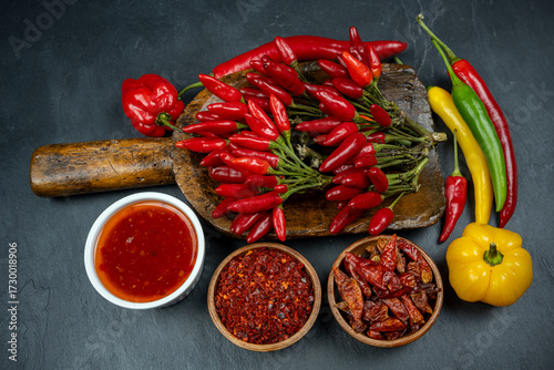 Hot spices: chili peppers with sauce and powder