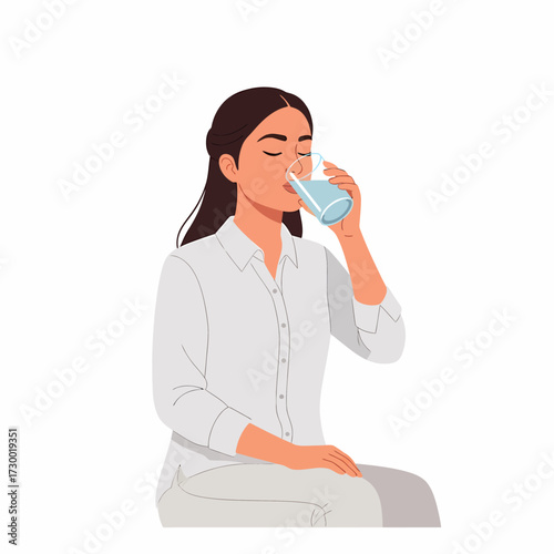 A young woman with dark hair, wearing a white shirt, sits and drinks a glass of clear, fresh water for hydration.