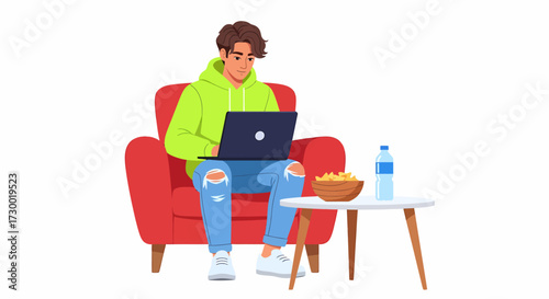 Young man in a green hoodie and ripped jeans sitting comfortably in a red armchair, working on a laptop with popcorn and water nearby.