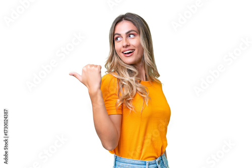 Young Uruguayan woman over isolated background pointing to the side to present a product