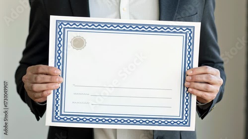 Economic incentives for sustainability concept. Holding a blank certificate with decorative borders against a neutral background.