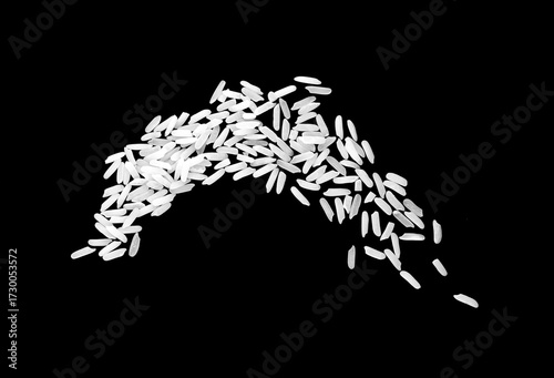 White rice grains scattered on black background, symbol of food, agriculture, and nutrition, perfect for culinary design, healthy diet concepts, and organic farming or kitchen ingredient themes.