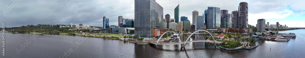 Naklejka premium Elizabeth Quay pedestrian bridge in Perth captured at sunset aerial view from flying drone