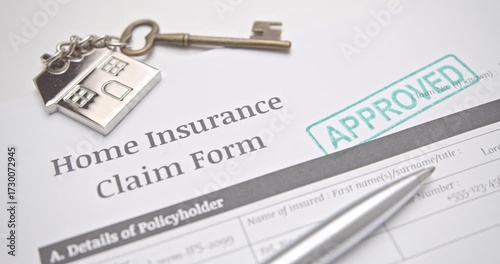 Home insurance claim form with approved stamp, key, and pen. Concept of property safety, financial protection, housing security, and insurance success.