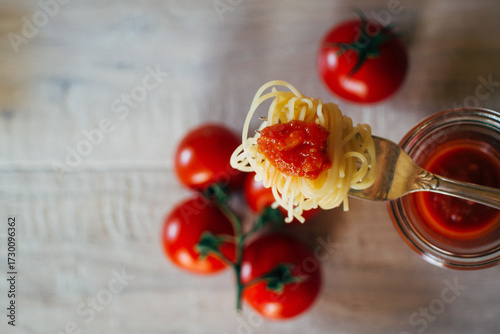fork with noodles and tomato sauce from above