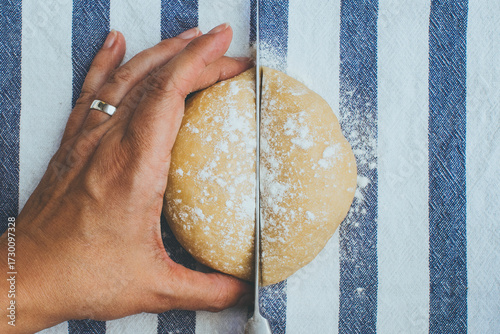 hand cutting dough in the middle