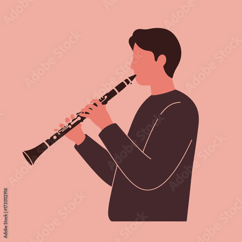 Man plays black clarinet against muted pink backdrop, facing right