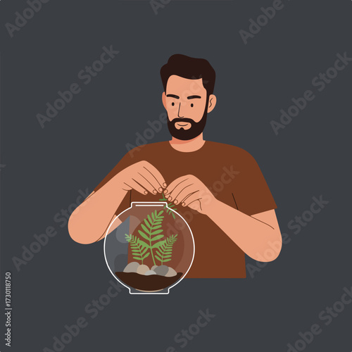 Man building terrarium with plants and rocks, on a dark background