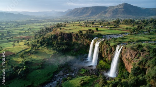 Rainbow Mist over Green Fields and Rocky Falls in Burkina Faso
