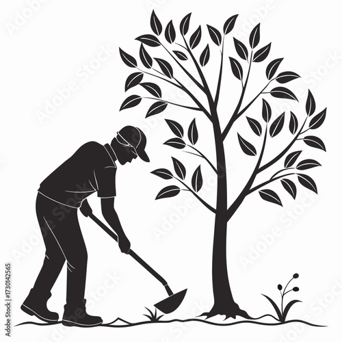 Silhouette of a man planting a tree with a hoe