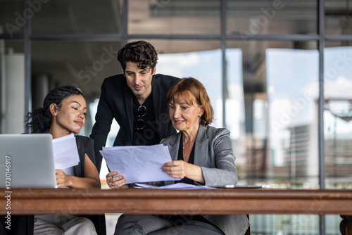 Group of managers or business workers share heir happiness after achieving project target. A moment of team's collective efforts in business workplace shared by members from different generations