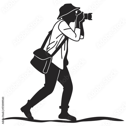 A silhouette of a photographer wearing a bucket hat and carrying a camera bag actively capturing a moment with their dslr camera