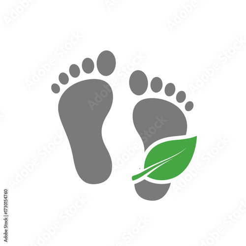Eco-friendly concept icon with grey human footprints and a green leaf, symbolizing a natural, sustainable lifestyle and a reduced ecological carbon footprint