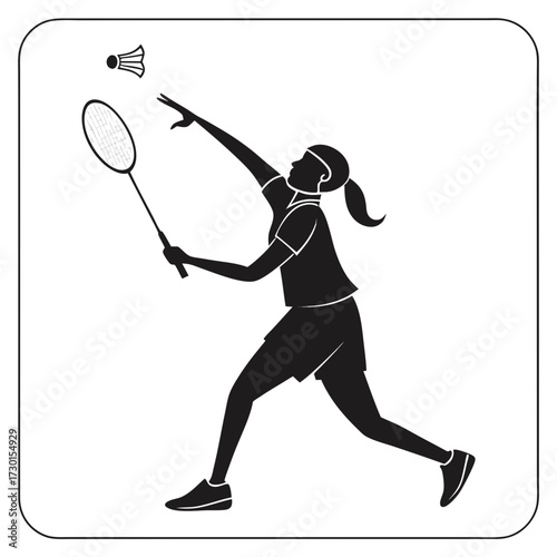 Silhouette of a female badminton player in action serving a shuttlecock with a racket capturing the dynamic movement and athleticism of the sport