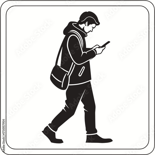 A young man wearing a hooded jacket and carrying a messenger bag walks while looking down at his smartphone engrossed in its screen