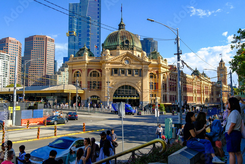 Flinders Street Station in Melbourne, Australia, with busy street life and modern skyscrapers in the background, showcasing the city’s historic and urban contrast.