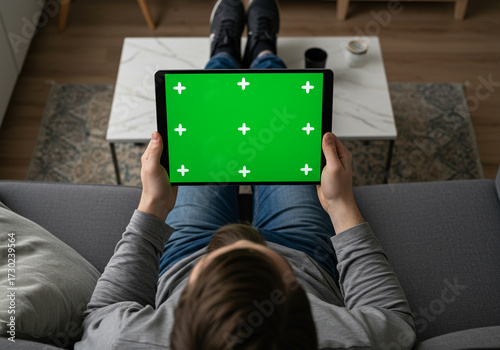Person holding tablet with green screen and tracking markers for editing, perfect for content creation and virtual production projects